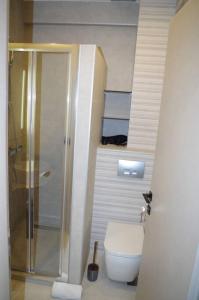 a bathroom with a toilet and a stair case at Seafront Centre Ouranoupoli in Ouranoupoli