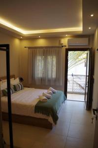 a bedroom with a bed and a sliding glass door at Seafront Centre Ouranoupoli in Ouranoupoli