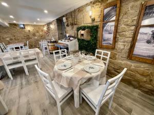 a dining room with a table and white chairs at Casa Susa in Poio