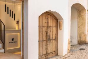 a wooden door on a wall in a store at Porta Nova Suites Altea - Adults Only in Altea