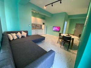 a living room with a couch and a table at Dream Apartments Saranda in Sarandë