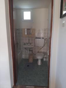 a bathroom with a toilet and a sink at ANNAS COTTAGE in Skala Sotiros