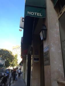a hotel sign on the side of a building at Hôtel Stanislas sans ascenseur in Paris