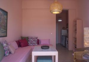 a living room with a couch and a table at Ann's apartment II in Lixouri +18 photos