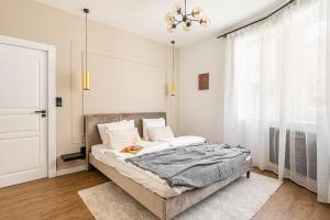 a bedroom with a bed and a chandelier at Asboth Boutique Budapest in Budapest