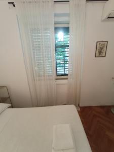 Posteľ alebo postele v izbe v ubytovaní Damjan Rooms