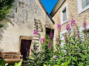 a building with purple flowers in front of a building at Ferienhaus am Eifelsteig in Alendorf