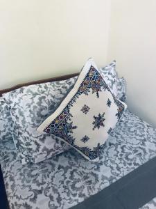 a pillow sitting on top of a bed at Abdessamad Appartement 1 in Essaouira