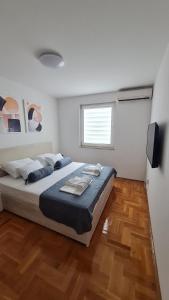 a bedroom with a large bed and a television at Memories apartment in Mostar
