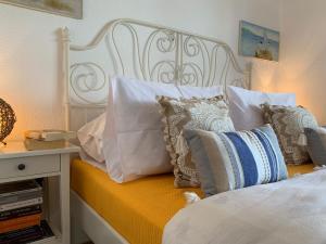 a bedroom with a bed with pillows on it at Mikiverna Seas the Day ! in Kalivia Poligirou
