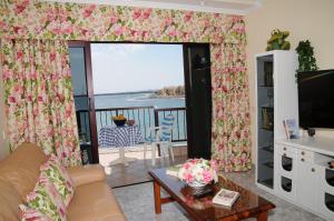 a living room with a view of the ocean at EmyCanarias Primera Línea De Playa in Arinaga