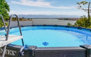 a large swimming pool with a view of the water at 6 Bedroom Cozy Apartment In Nin in Nin
