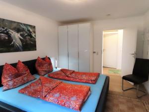 a bedroom with two beds with red pillows at Ferienwohnung Bodenseeblick in Meersburg