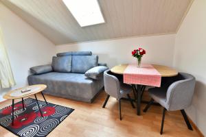 a living room with a table and a couch at Guesthouse Ante Hodak in Seliste Dreznicko