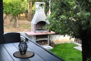 a outdoor oven sitting on top of a table at Apartment by the sea Renata in Punta Skala in Petrcane