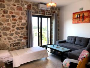 a living room with a couch and a table at Oikia Stone House in seaside Kalo Chorio in Agios Nikolaos