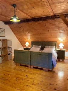 a large bedroom with a large bed with two lamps at Jurček Holiday Home in Kotlje