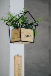 a plant holder with the words home on it at Ehha Home in Biograd na Moru