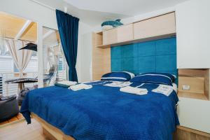 a bedroom with a blue bed with a blue blanket at Ehha Home in Biograd na Moru