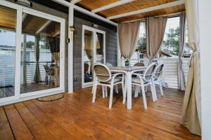 a dining room with a table and chairs on a porch at Ehha Home in Biograd na Moru