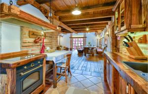 a kitchen with a stove and a table in a room at Lovely Home In Prosenik Gubasevski in Ravnice