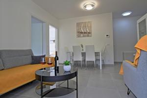 a living room with a couch and a table with wine glasses at Bonaca in Senj