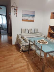 a living room with a couch and a table at Casa vacanze Mare Blu in Bellaria-Igea Marina