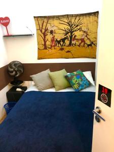 a bedroom with a bed and a painting on the wall at Pinheiros Hostel & Food in Sao Paulo