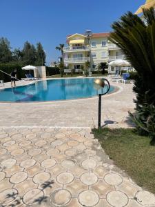 a swimming pool with a light next to a building at Fantastic Apt-2 min walk from Belek Cent’r Antalya region, great for golf lovers in Belek