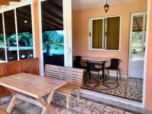 a porch with two benches and a table at Delfini Holiday Homes in Ulcinj