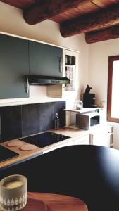 a kitchen with a stove and a counter top at La Louronnaise in Bordères-Louron