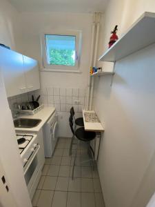 a small kitchen with a table and a sink at Hubert in Berlin