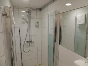 a bathroom with a shower with a glass door at Ronneby Cityhotell in Ronneby