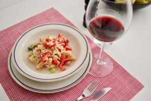 a plate of food next to a glass of wine at Palazzo Palloni Boutique Apartment in Sorano +12 photos