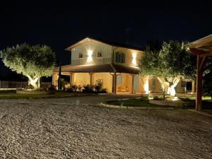 a house with trees in front of it at night at B&B Il Melograno in Fano