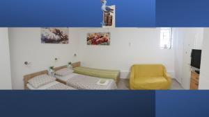 a living room with a couch and a yellow chair at Apartments Viking - In The OLD TOWN of SPLIT in Split
