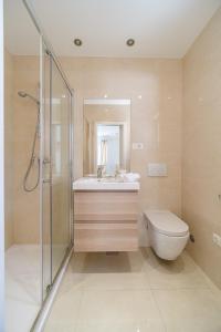 a bathroom with a sink and a shower and a toilet at Villa TM with private heated pool, poolhouse & private garage in Milna
