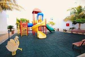 a playground with a slide and a slideintend at Al Jar Resort - Families Only in Rayyis