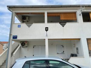 une voiture garée devant une maison dans l'établissement Apartment Near The Beach, à Privlaka