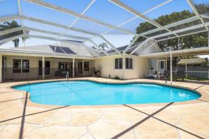 a swimming pool with a pergola in a house at Vacation Station in Bradenton