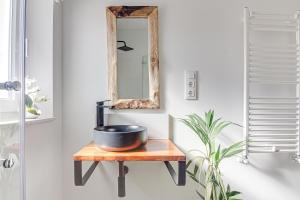 a mirror and a bowl on a table in a bathroom at Apartamentos Playa de Finisterre in Fisterra +56 photos
