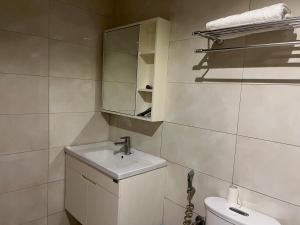 Baño blanco con lavabo y aseo en Wehome 忆江南民宿 en Dubái