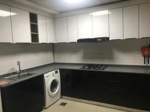 a kitchen with a washing machine and a sink at Wehome 忆江南民宿 in Dubai