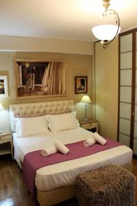a bedroom with a large bed with two towels on it at Luxury Sea View in Volos