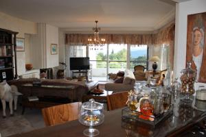 a living room with a table and a living room with a couch at Luxury Sea View in Volos