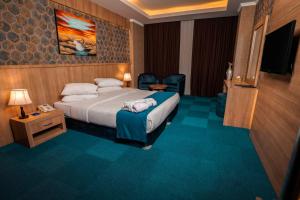 a hotel room with a bed and a television at Sipan Hotel in Erbil