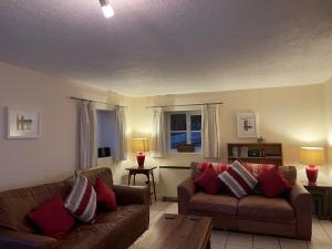 a living room with two couches and a table at Holly Lodge in Norwich +16 photos