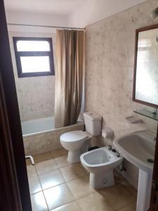 a bathroom with a white toilet and a sink at Atlantic Dawn in Los Cancajos