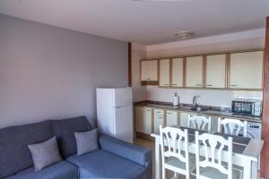 a living room with a couch and a kitchen at Atlantic Dawn in Los Cancajos