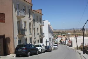 a row of cars parked on a street with buildings at Fuente Lebana Labradores in Facinas